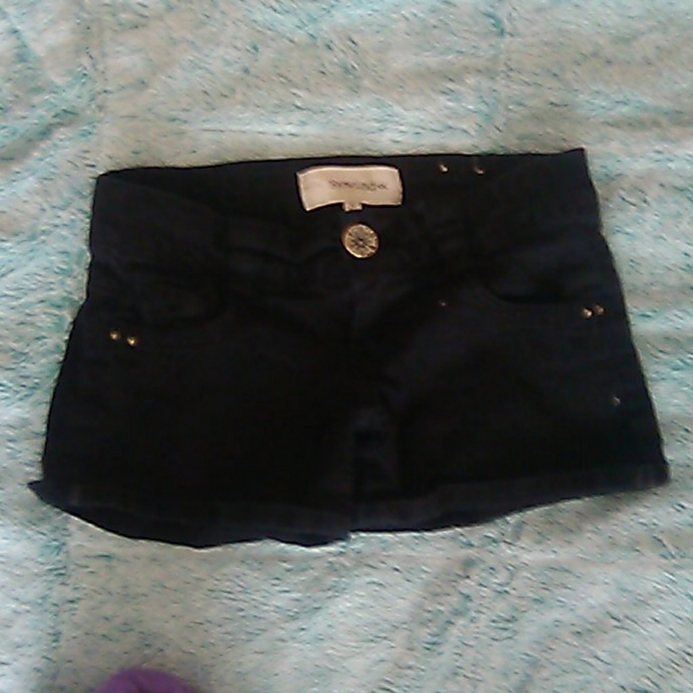 A pair of black short shorts.